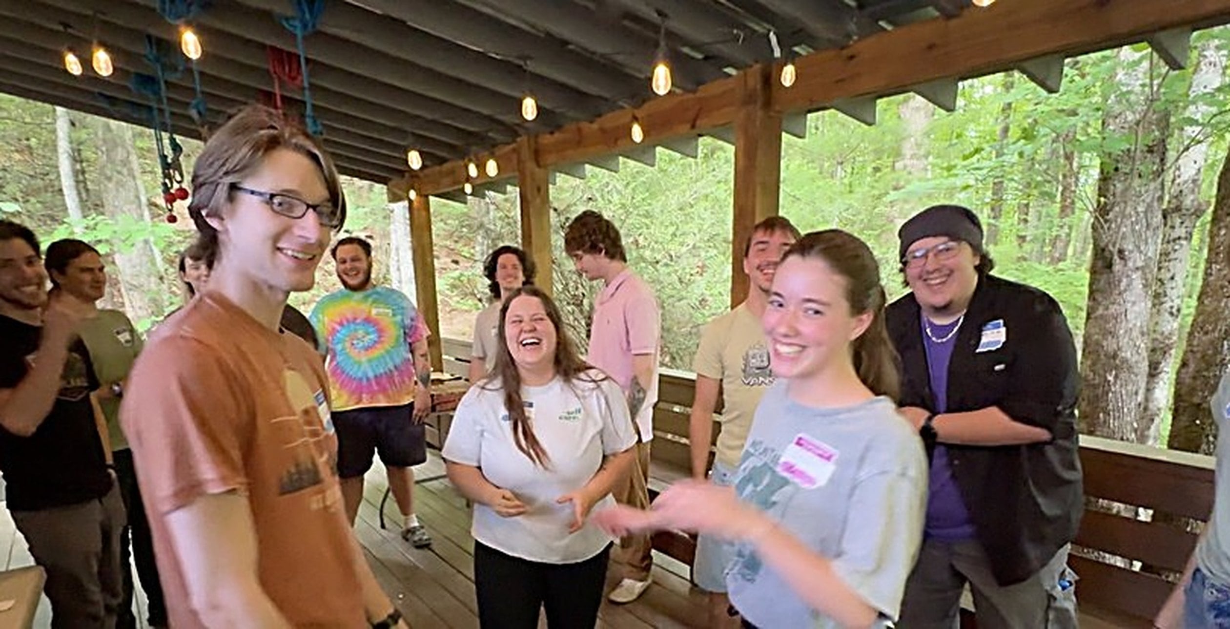 A team laughing together on the covered deck