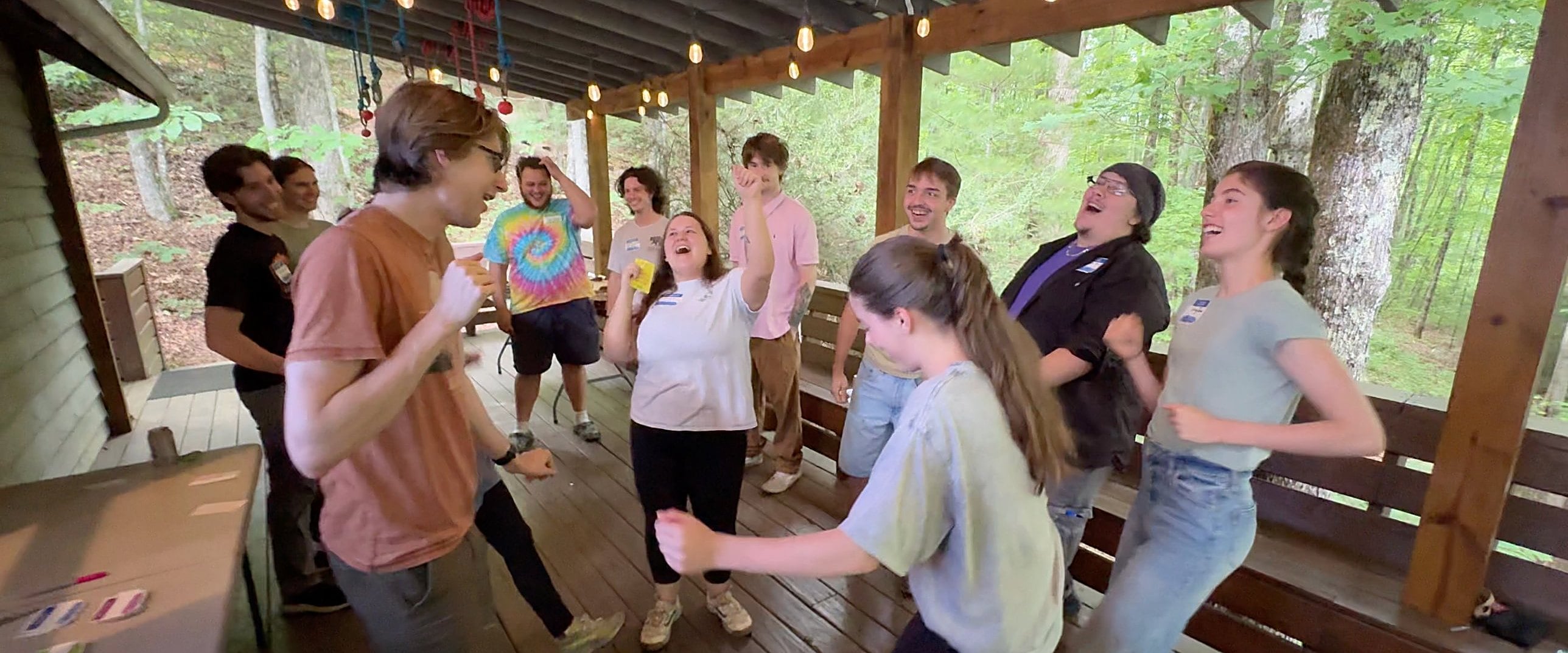 A group laughing and cheering together on the covered deck at Highlands Aerial Park